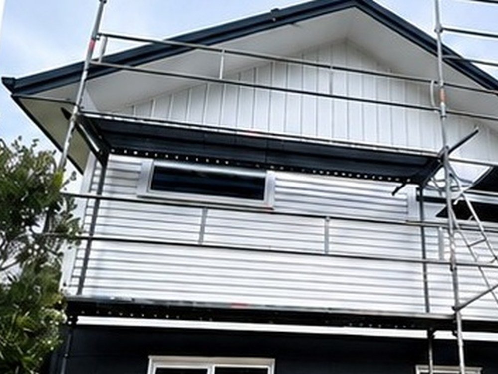 Two-storey house exterior after repaint in dark cladding, Wellington
